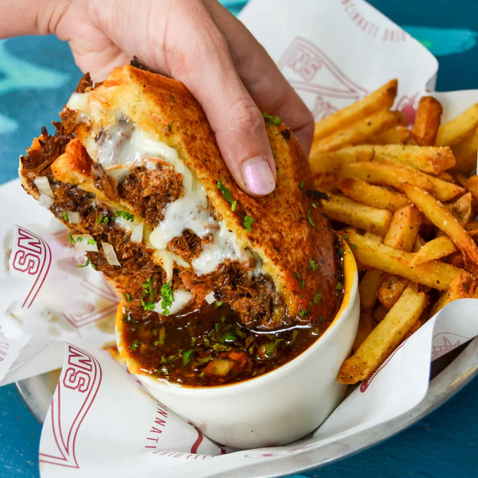 Birria grilled cheese with consommé dip and fries