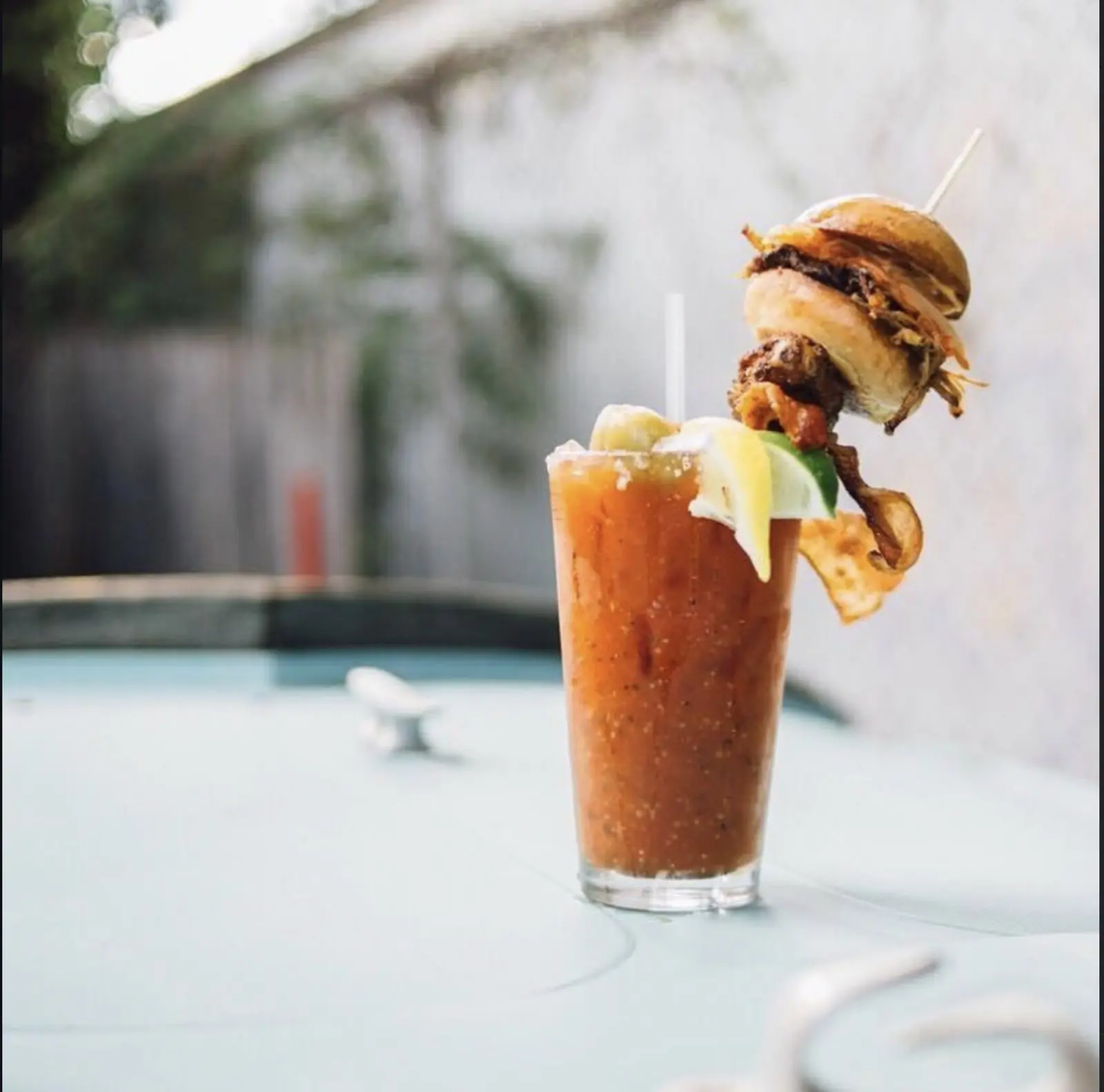 The famous NSYC Yacht Club Bloody Mary garnished with a slider, bacon and a smoked wing