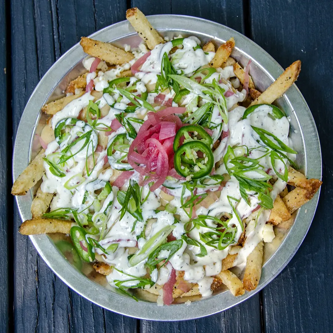 Creature Fries — three-cheese mornay, jalapeño, pickled red onion, scallions, Nascar sauce