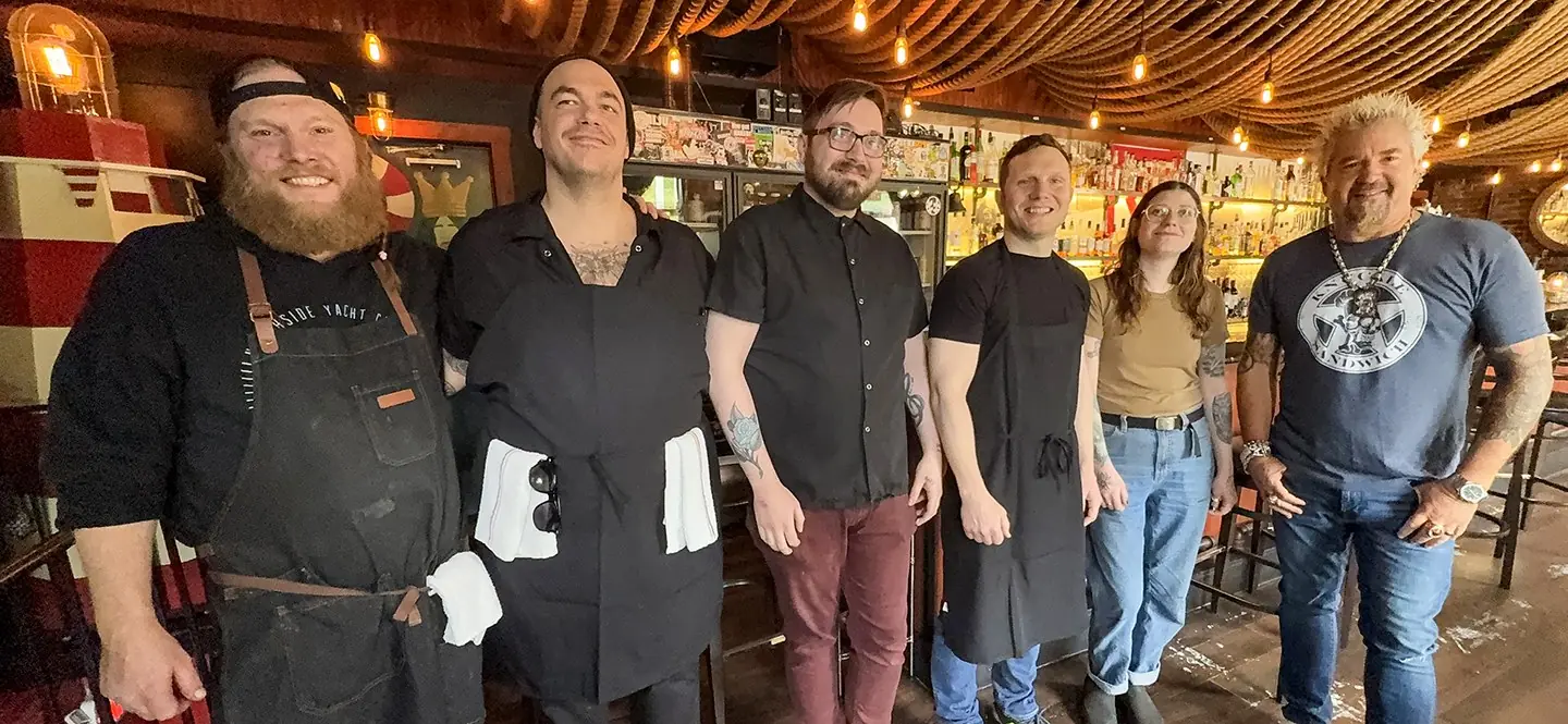 Guy Fieri with the NSYC kitchen and bar crew during Diners, Drive-Ins and Dives filming