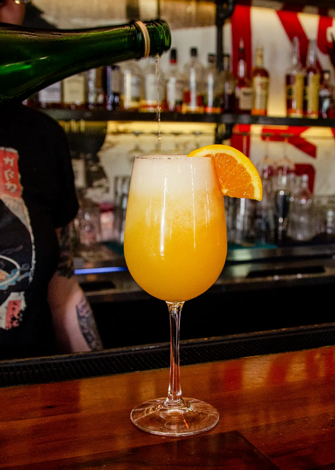 NSYC Mimosa — sparkling wine poured over fresh orange juice at the bar