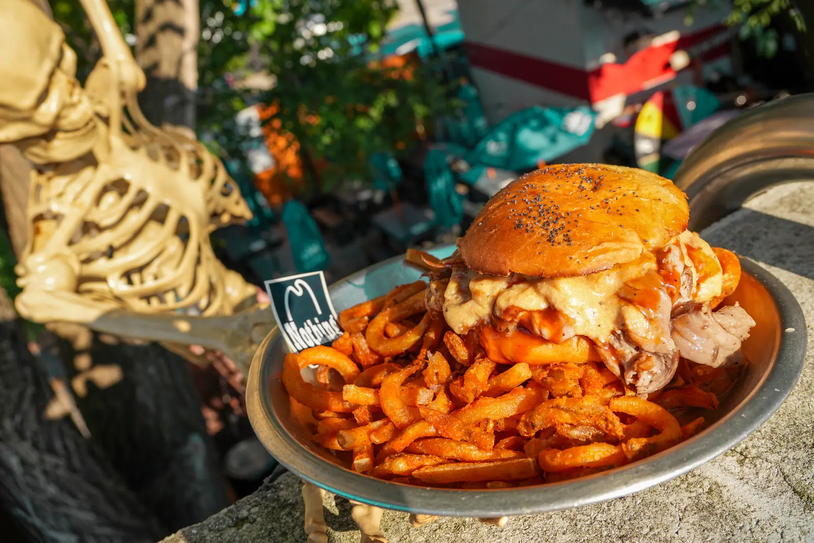 The Nihilist RB's with curly fries, served by a skeleton hand on the patio