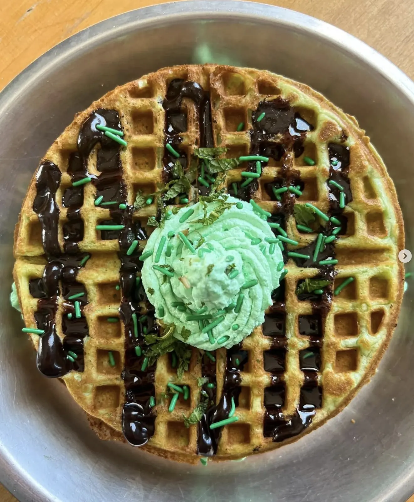 Wake n Bake Waffles with chocolate drizzle, mint whipped cream and green sprinkles